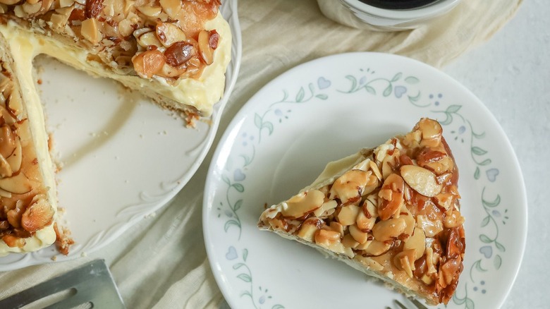 Bienenstich cake slice on plate next to whole cake