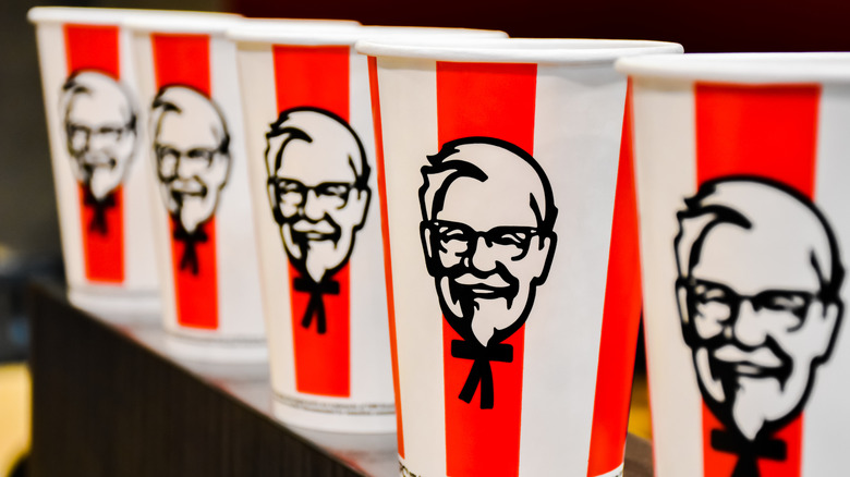 KFC cups with Colonel Sanders' face lined up in a row