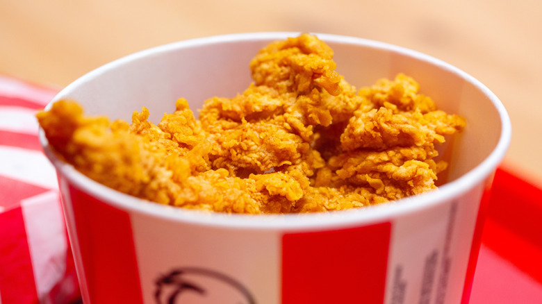 Closeup of the top of a KFC bucket with the chicken visible inside