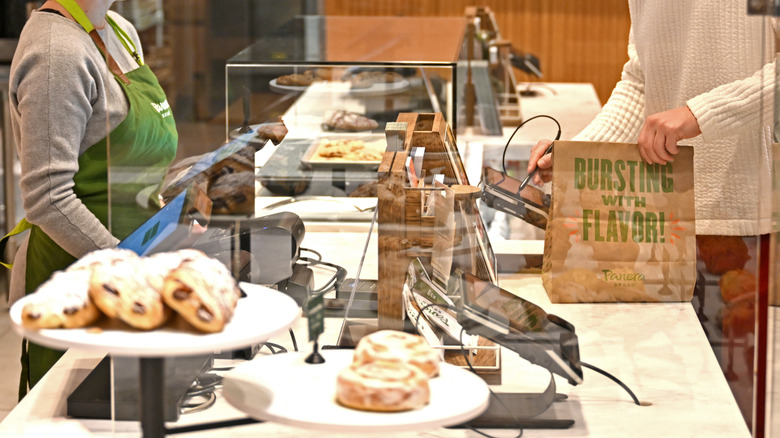 Customer picking up to-go order from Panera Bread