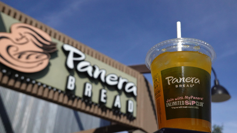 Panera cup in front of Panera sign