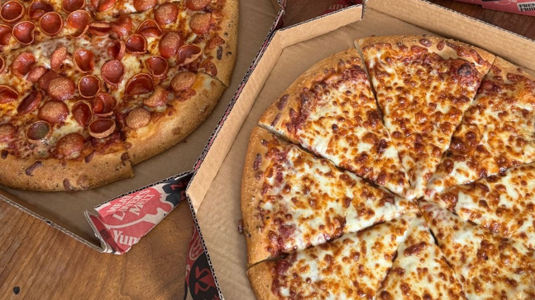 Two Pizza Hut pizzas in boxes with new hand-tossed crust
