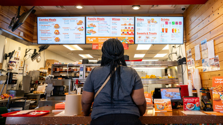 customer ordering food at Popeyes