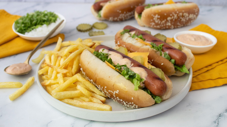 Big Mac hot dogs on plate with fries