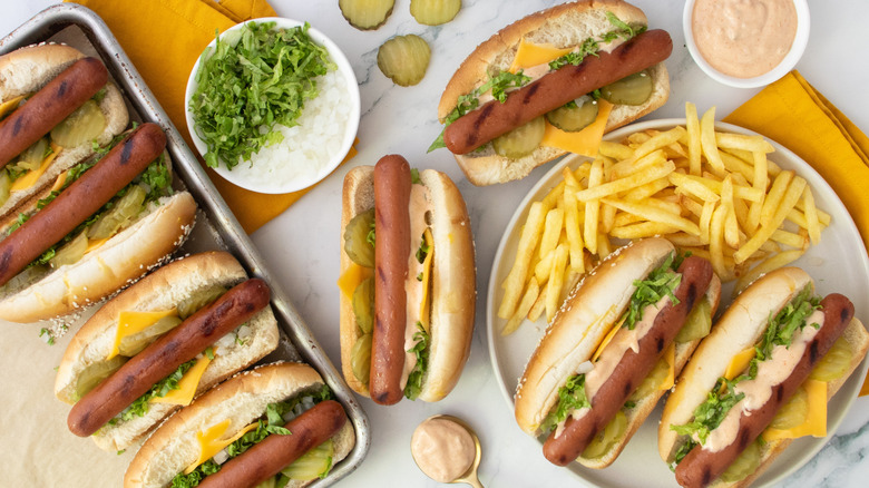 Big Mac hot dogs with fries and various toppings