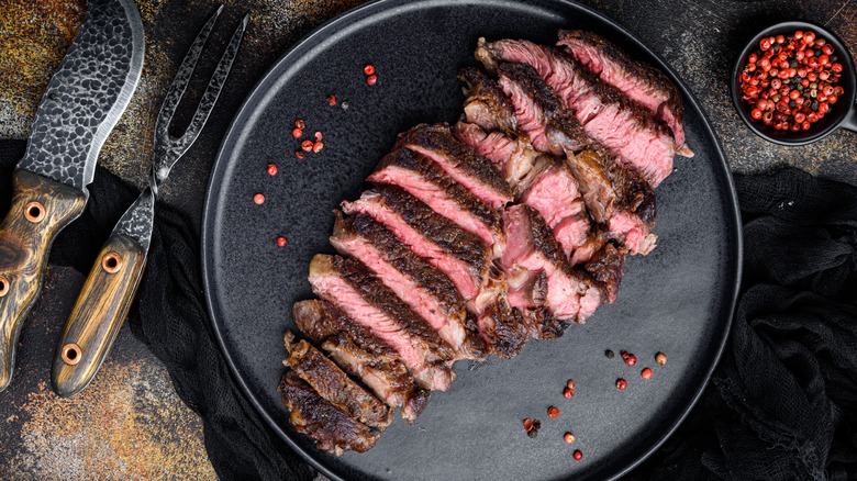 juicy steak and pink peppercorns