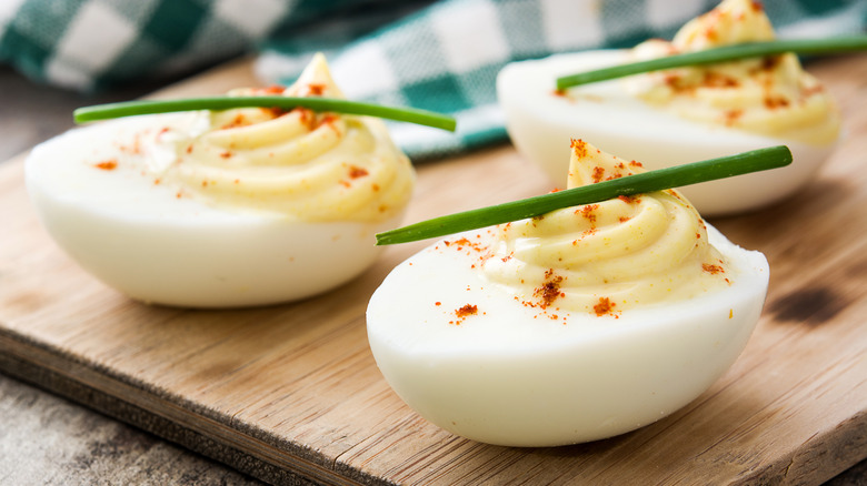 deviled eggs on cutting board