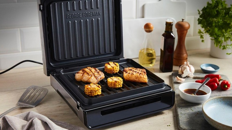 Open George Foreman Grill with fish and corn