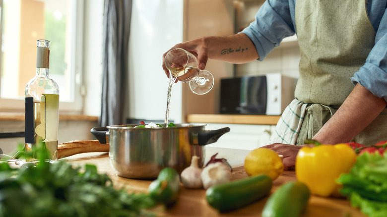 white wine being poured into pan