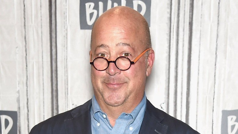 Andrew Zimmern smirking for cameras at publicity event