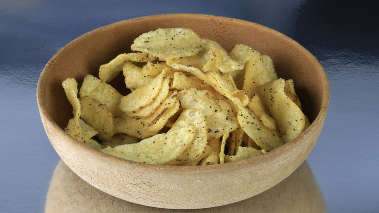 Sour cream and onion chips in a wooden bowl