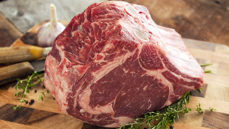 Prime rib coming to room temperature on a cutting board