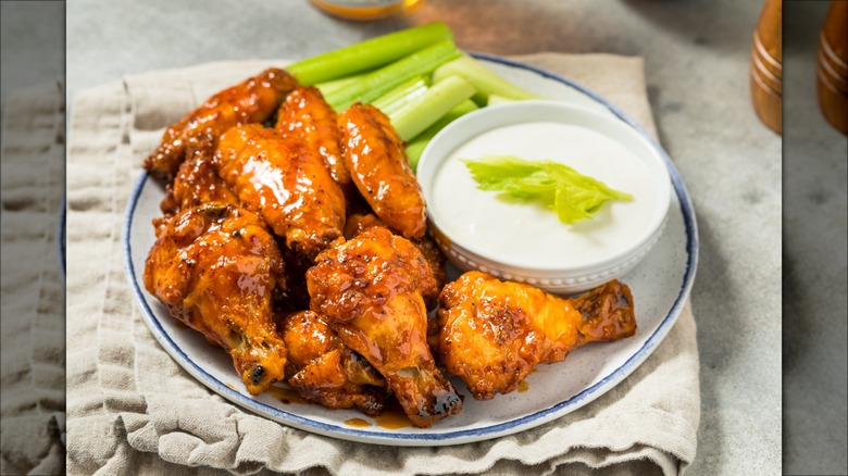 Chicken wings, celery, and ramekin of ranch dressing