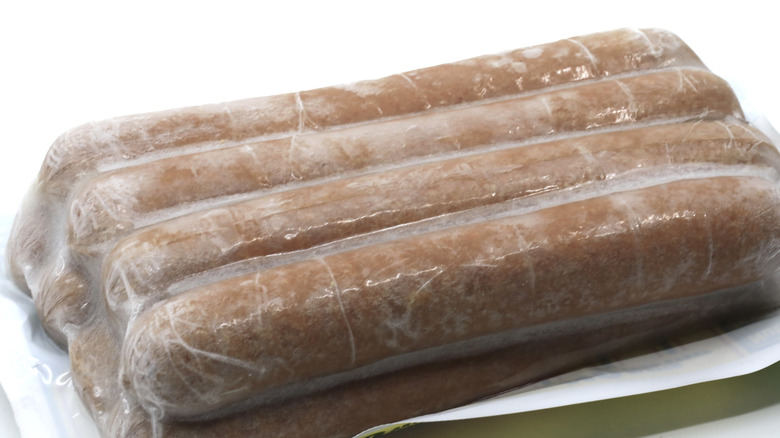 Pack of frozen sausages on a white surface