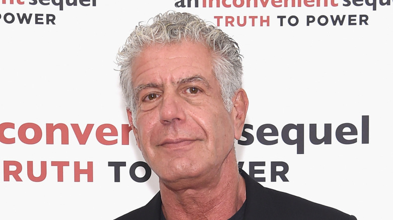 anthony bourdain posing for photo