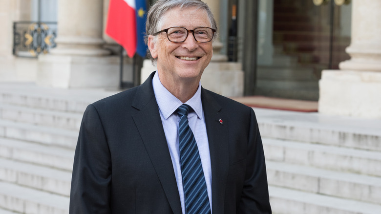 Bill Gates with flags in background