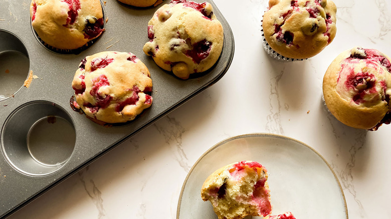 cranberry muffins in pan and on plate