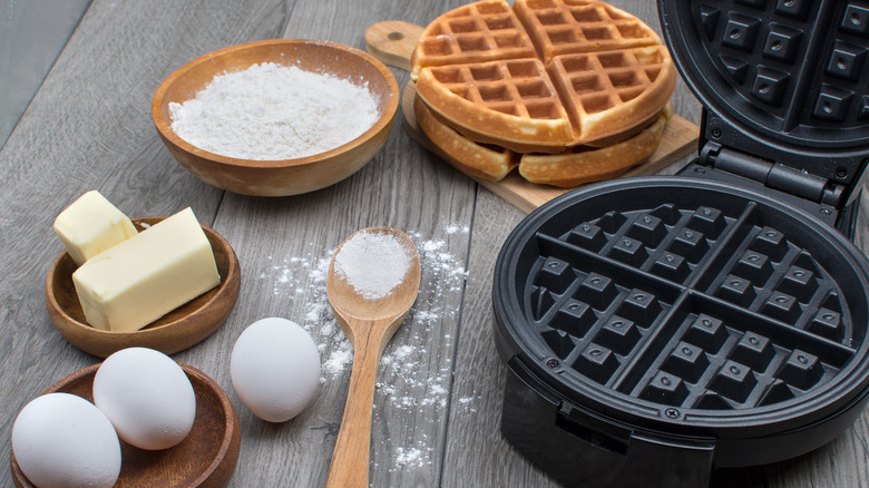 Waffles next to waffle iron