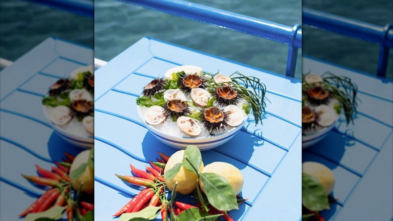 Shellfish, sea urchins, and fresh produce on dining patio at Lo Scoglio