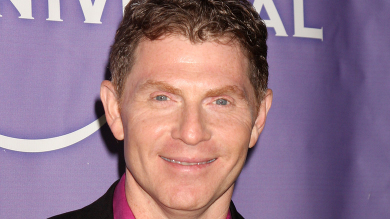 Bobby Flay in pink shirt and black jacket