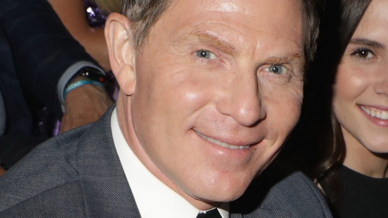 Bobby Flay grinning at event