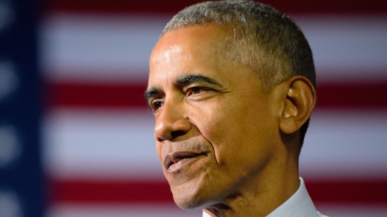 Barack Obama in front of American flag background 