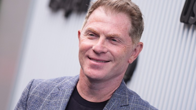 Bobby Flay smiling at a red carpet event