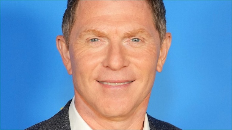 Bobby Flay smiling on blue background