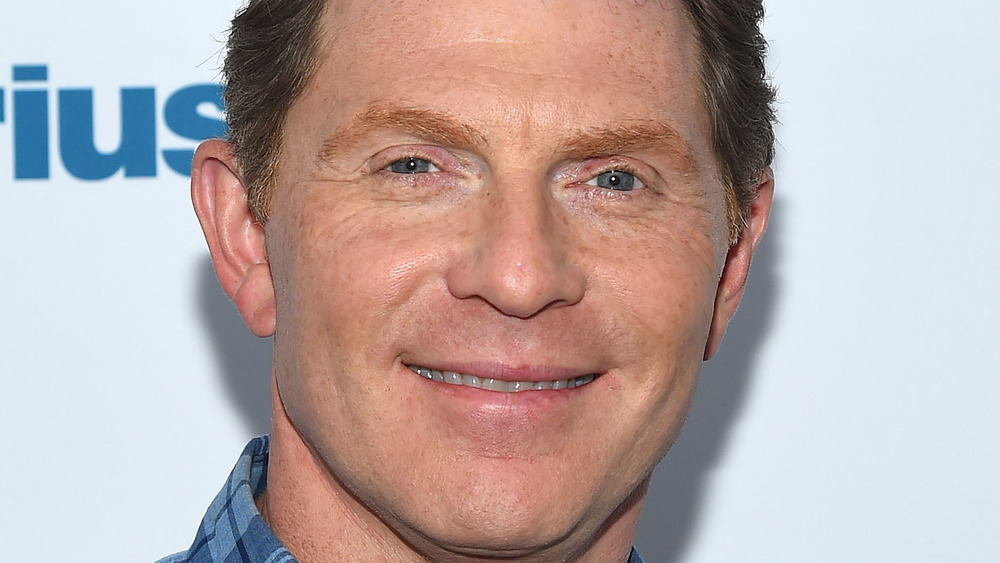 Bobby Flay smiling on red carpet