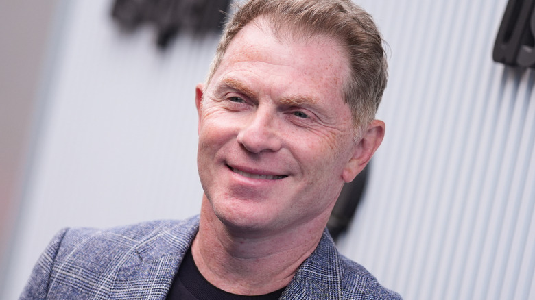Bobby Flay in a plaid sports coat at the U.S. Open.