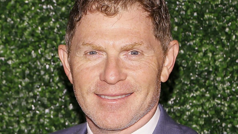 Bobby Flay smiling against green backdrop