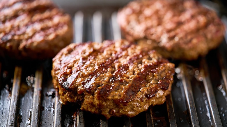 Burger patties cooking on a grill