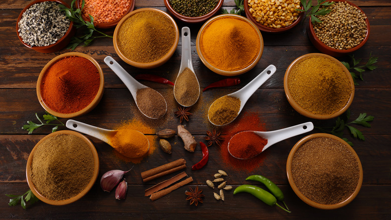 Various spices in bowls and spoons