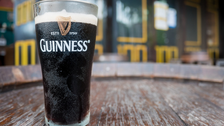 Pint of Guinness beer with blurred bar background