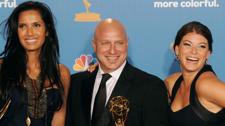 Padma Lakshmi, Tom Colicchio, and Gail Simmons smile in black