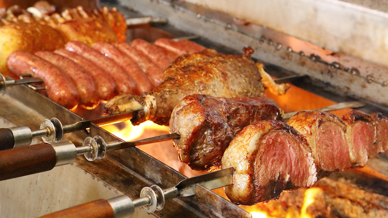 churrasco meat on skewers over open grill