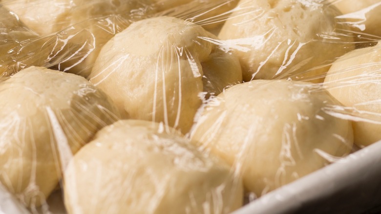 Dough rising under plastic wrap