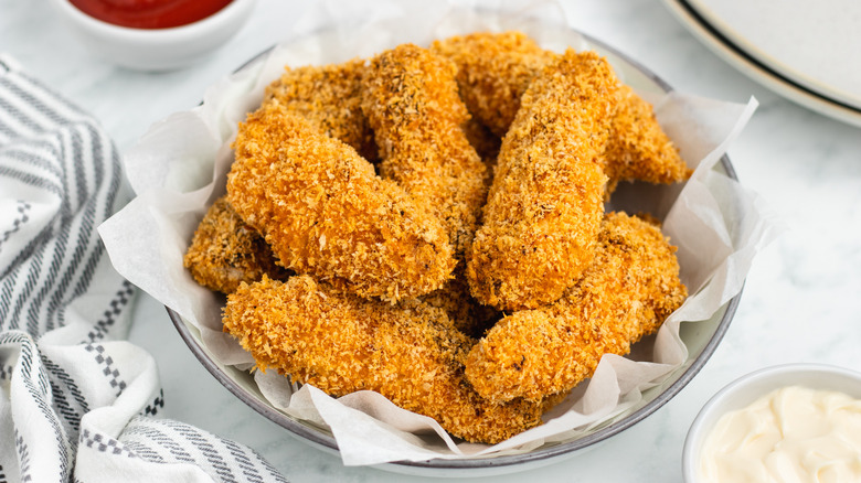breaded and baked chicken tenders in bowl 