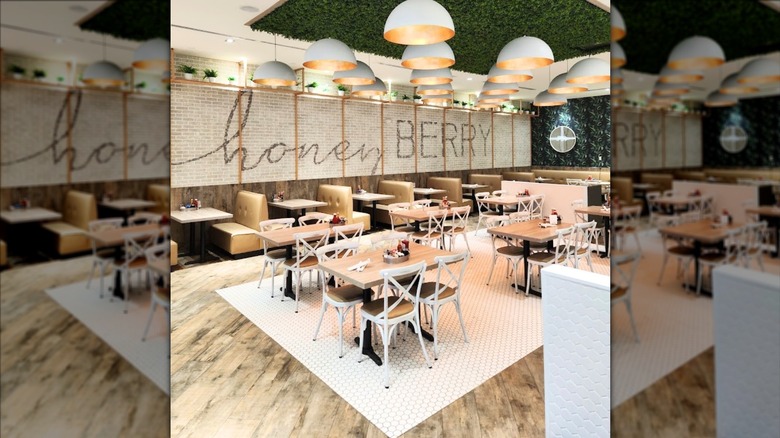 Empty dining room interior of Honey Berry Cafe with tables and booths