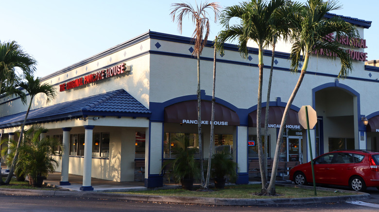 exterior entrance of original pancake house restaurant in florida with palm trees
