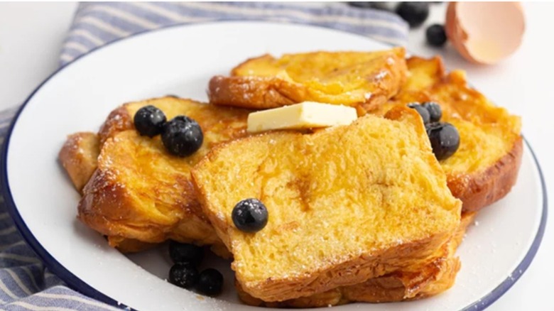 A plate of French toast slices with blueberries