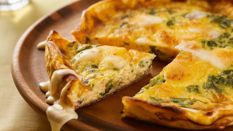 A sliced frittata on a cutting board