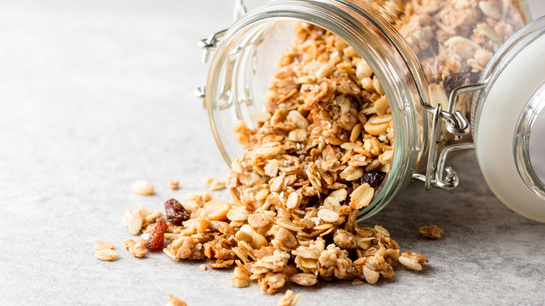 An open jar spilling homemade granola