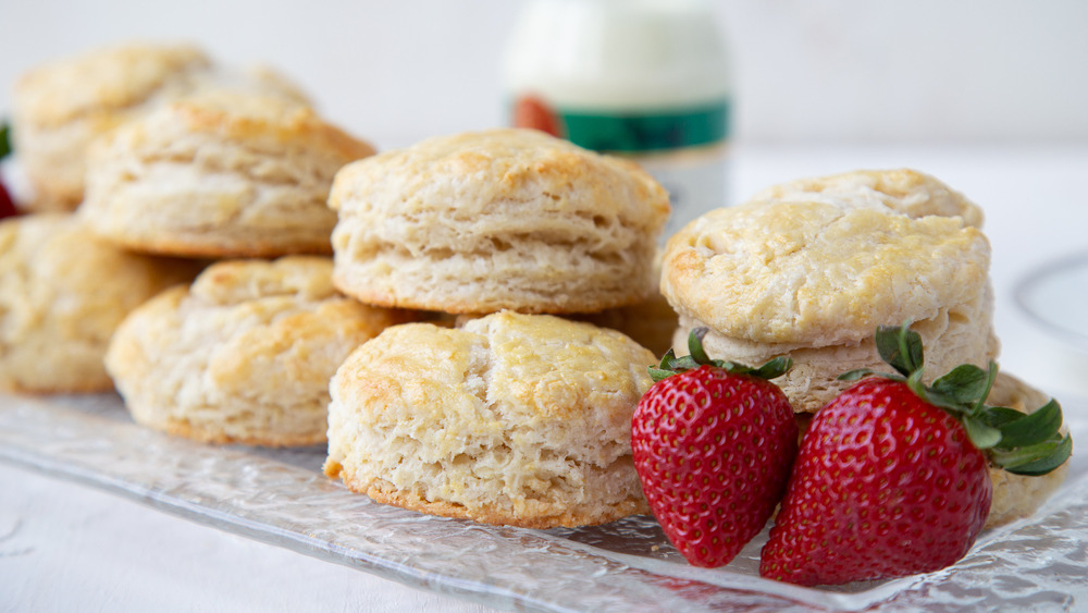 british scones on glass plate with fresh strawberries