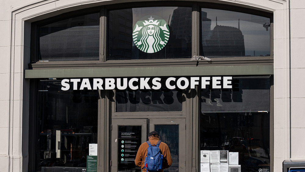 Person entering Starbucks coffee shop