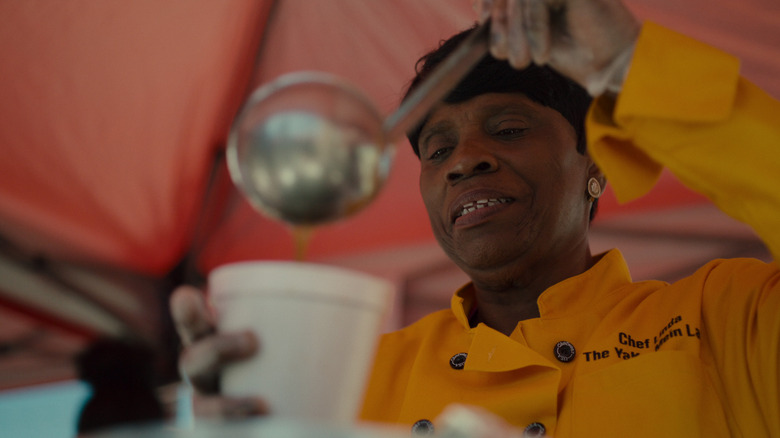 A woman serving soup