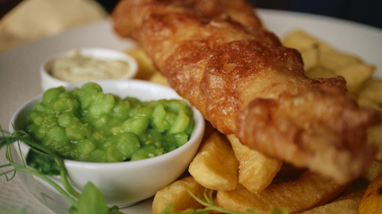 Mushy peas alongside fish and chips