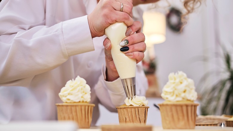 Woman decorating cupcakes