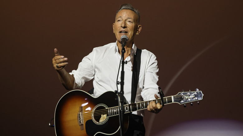 Bruce Springsteen at mic with guitar