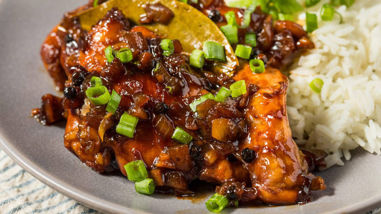 Chicken adobo on a plate with white rice